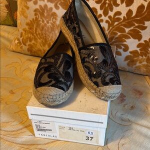 Fabiola’s black sequin trim espadrille flats.